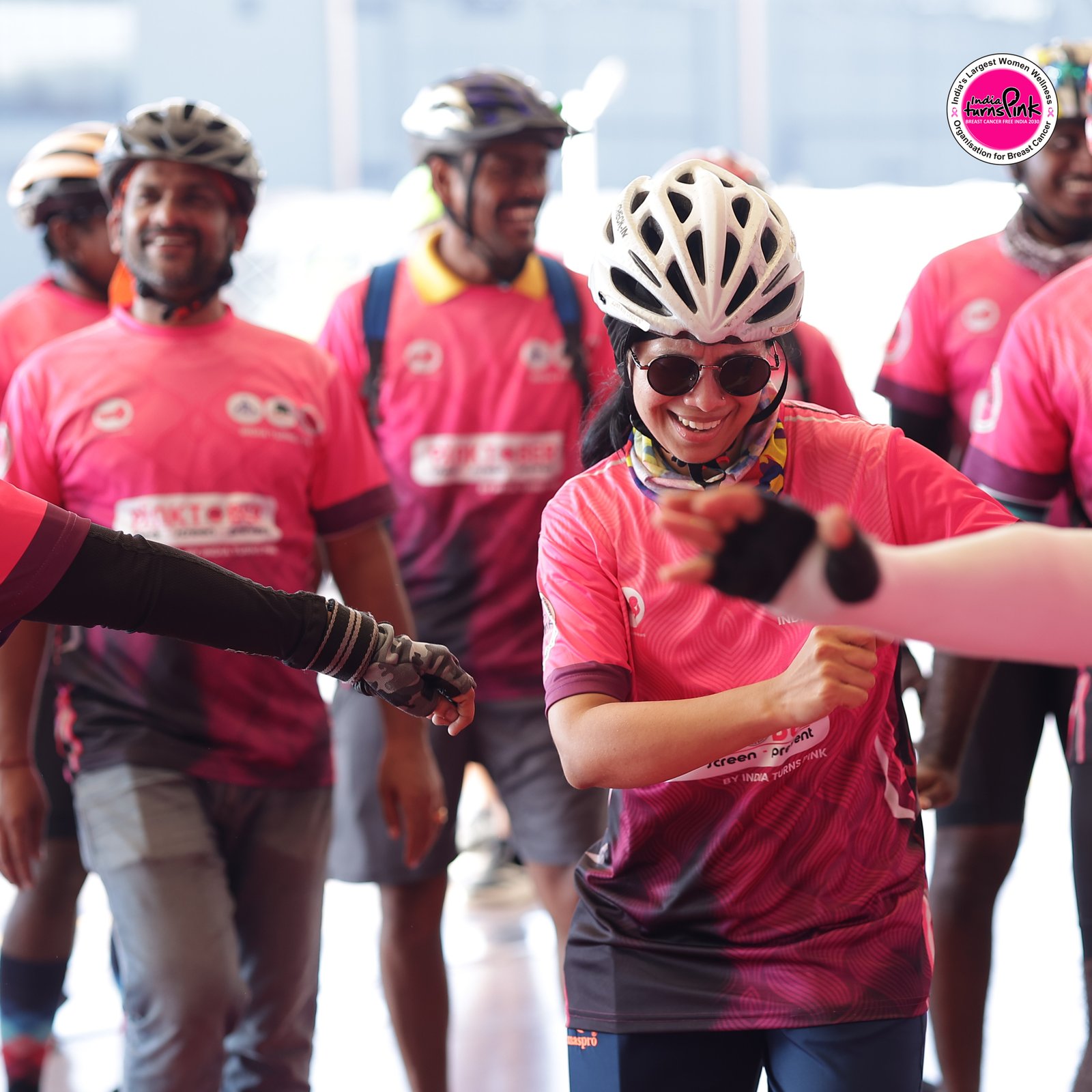 An awareness programme with participants holding pink materials