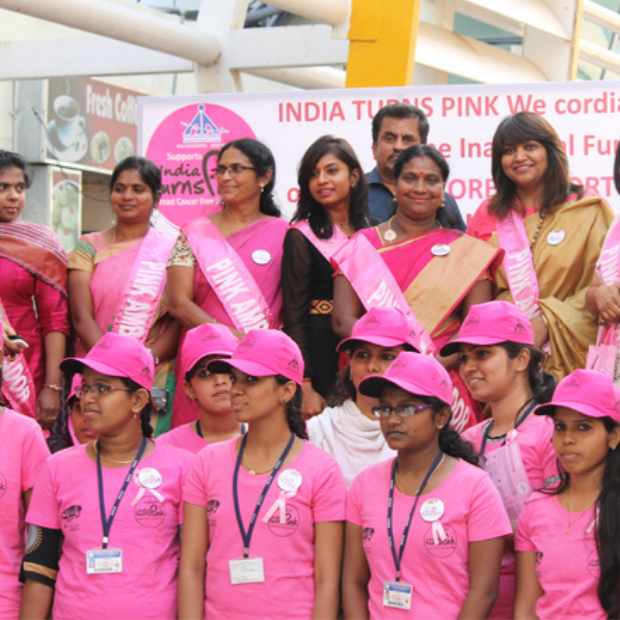 Volunteers in Pink Ambassador sashes at the inaugural function of an India Turns Pink airport programme